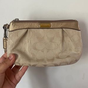 Coach beige wristlet. 8 in. wide. Spacious, C letters a bit faded.